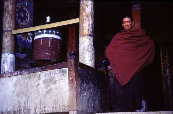photo of India, Ladakh, around Leh, buddhist monk and turning prayer wheel