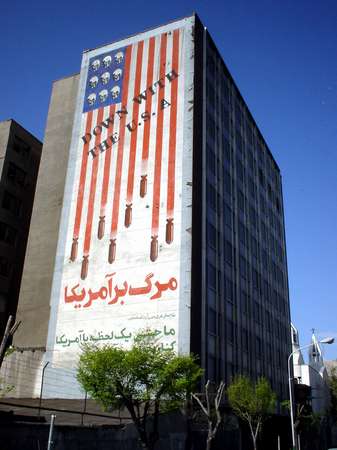 photo of Iran, Tehran (Teheran), propaganda billboard of the Iranian revolution on an appartment block, 'down with the USA', bombs falling from the American flag and skulls instead of stars