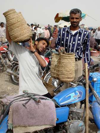 photo of Iran, Persian sea coast, around Bandar Abbas, market vendors and motorbike on the Thursday market in Minab