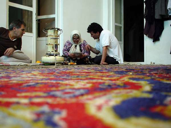 photo of Iran, Bam, interior of Iranian house with carpet and stove