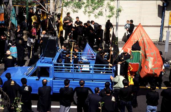 photo of Iran, Mashad, mourning procession of Iranian men in black in commemoration of the martyrdom of imam Hussein (Hussain) during Moharram