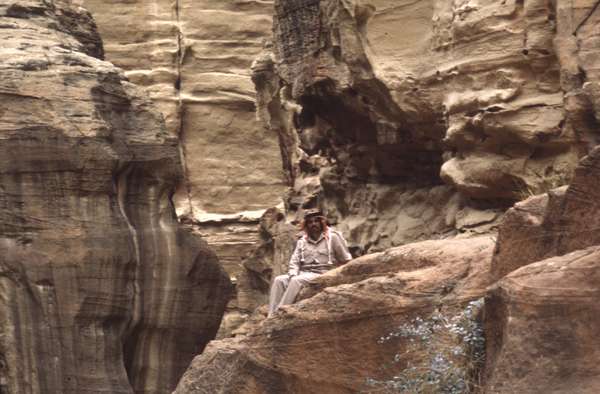 photo of Jordan, Petra, Arab bedouin man sitting on a rock