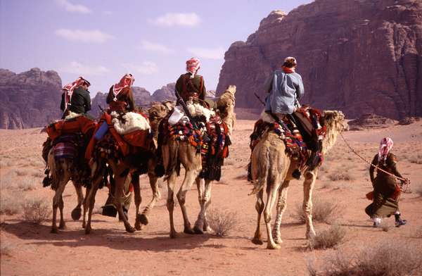 photo of Jordan, Wadi Rum desert, colorfully uniformed Bedouin Desert Police on their camel