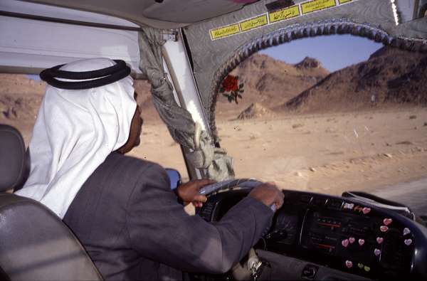photo of Jordan, palestinian bus driver, driving through the Wadi Rum desert