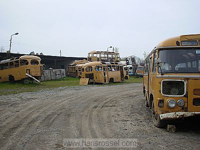 photo of Nagorno Karabakh, Mardakert (Martakert), run down bus station with broken yellow busses of the Soviet era