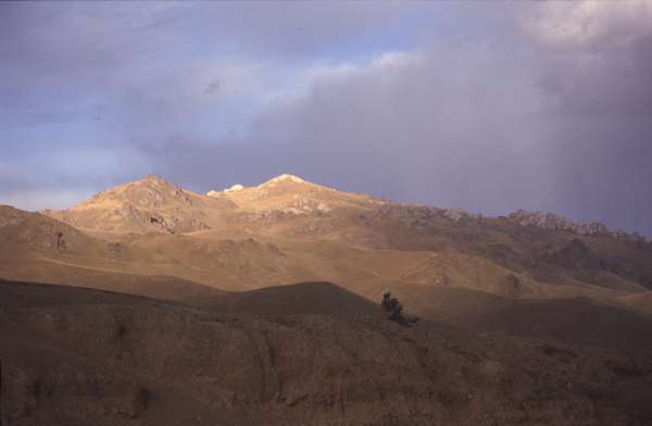 photo of kyrgyzstan, road to Torugart pass (border with China), old kyrgyz couple sitting in mountains