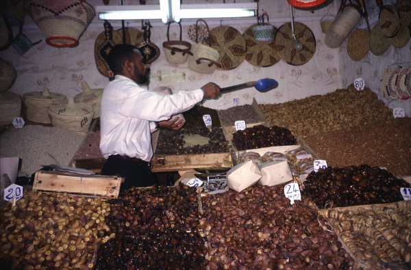 photo of Morocco, Marrakesh, nuts vendor in souq market