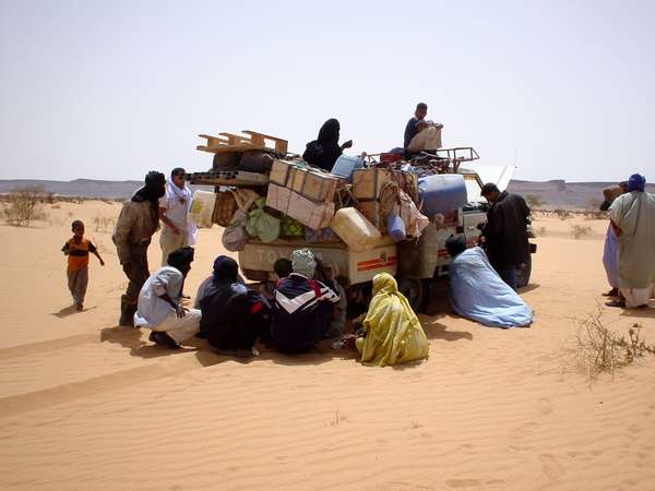 photo of Mauritania, a very typical image of Mauritania : an heavily overloaded Toyota Hilux with a breakdown in the middle of the desert; no fun at 48&deg;C in the shadow and a burning hot and strong Sahara wind which dries you out in no time