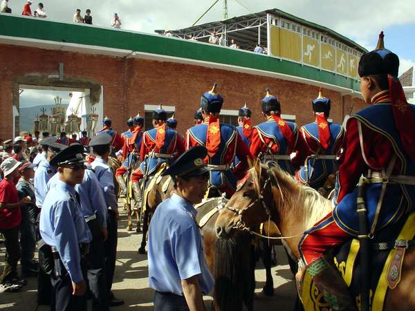 photo of Mongolia, horses and riders entering the gate of the stadium of Ulaan Baatar (Ulaanbaatar, Ulan Bator) for the opening ceremony of Naadam, the Mongolian National holiday