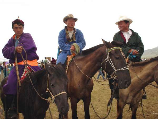 photo of Mongolia, in the fields outside Ulaan Baatar (Ulaanbaatar, Ulan Bator), three Mongolian horse riders dressed up for Naadam, the Mongolian National holiday