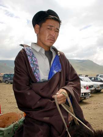 photo of Mongolia, in the fields outside Ulaan Baatar (Ulaanbaatar, Ulan Bator), Mongolian horse rider on his horse dressed up for Nadam (Naadam), the Mongolian National holiday