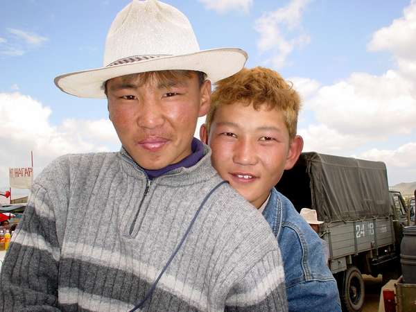 photo of Mongolia, in the fields outside Ulaan Baatar (Ulaanbaatar, Ulan Bator), Mongolian youngsters riding their horse on Nadam (Naadam), the Mongolian National holiday