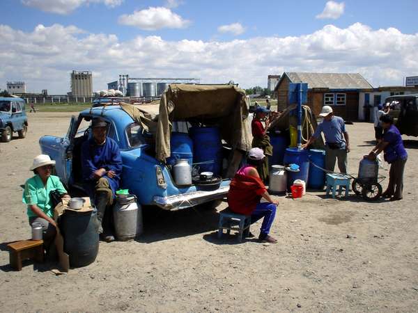 photo of Central Mongolia, Tsetserleg, market vendors selling airag or kumiss (koumiss), Mongolian fermented mare's milk