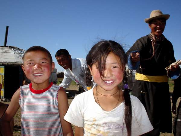 photo of Mongolia, Mongolian children and their family in front of their yurt