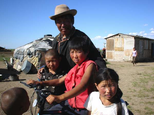 photo of Mongolia, Mongolian father with children in front of their house
