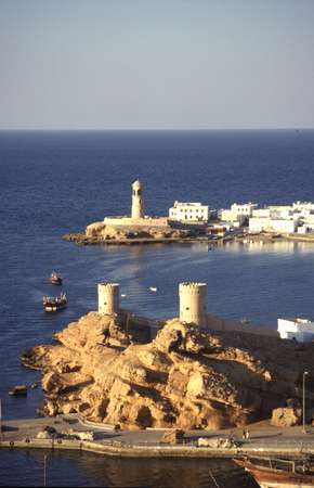 photo of Oman, fort towers in the harbour of Sur, a fishermen's town on the Arabian sea. In the past this fishing village has been well known for its Dhow building and was Oman's main centre of trade with East-Africa