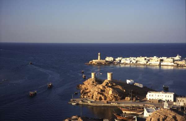 photo of Oman, fort towers in the harbour of Sur, a fishermen's town on the Arabian sea. In the past this fishing village has been well known for its Dhow building and was Oman's main centre of trade with East-Africa 
