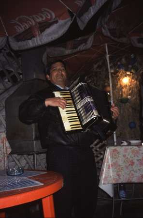 photo of Romania, Bucharest, Roma (Romani) gypsy musician playing gipsy music on his accordion