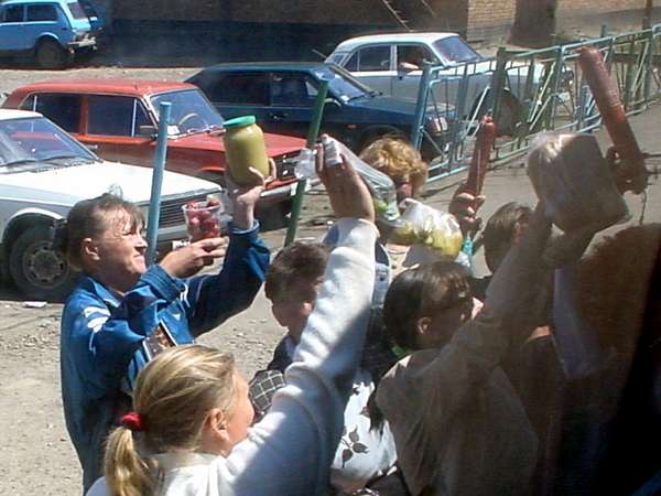 photo of Russia, women selling home made products via the windows in a Russian train station;