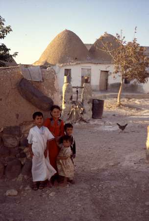 photo of Syria, around Aleppo, Syrian children in a village with beehive houses, bedouin mud homes