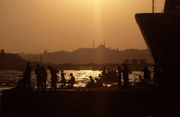 photo of Turkey, Istanbul, fisherman and sunset above the Bosphorus