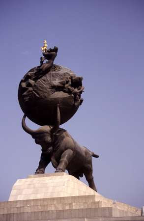 photo of Turkmenistan, Ashgabat, the earthquake monument : a giant bull shakes the earth above as a woman clutches her golden boy, the President himself, in her arms. The terrible earthquake of 1948 measured 8 on Richter and killed in a few seconds more than 100.000 people, among which Nyazov's mother