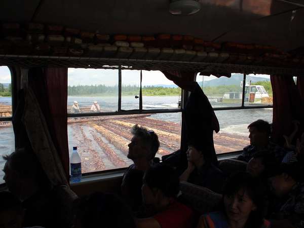 photo of Tuva, on the Yenisey (Yenisei) river, inside the ferry boat from Kyzyl to Toora Chem (Toora-Xem, Toora-Khem), tree trunks floating in the stream