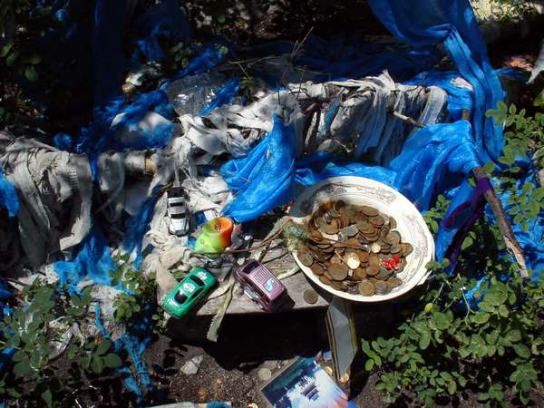 photo of Tuva, Tuvan shamanism and paganism, south of Kyzyl, around Erzin, east of Moren, blue cloth and religious shaman offerings and sacrifices for the spirits on an offer altar in the mountains