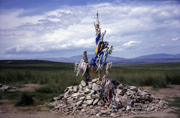 photo of Siberia, Tuva, Tuvan Siberian shamanism and paganism, fields around Kyzyl, Sacred Ovaa (shamanic altar) made of stones, dry branches and cloth where Tuvans perform religious shaman offerings and sacrifices for the spirits