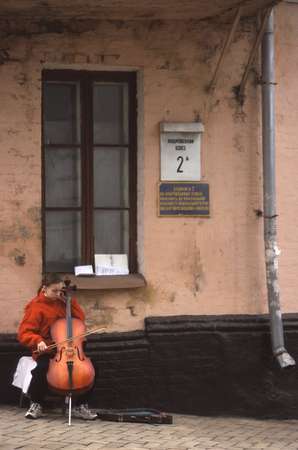 photo of Ukraine, Kiev old town, girl playing violin in street in Podil
