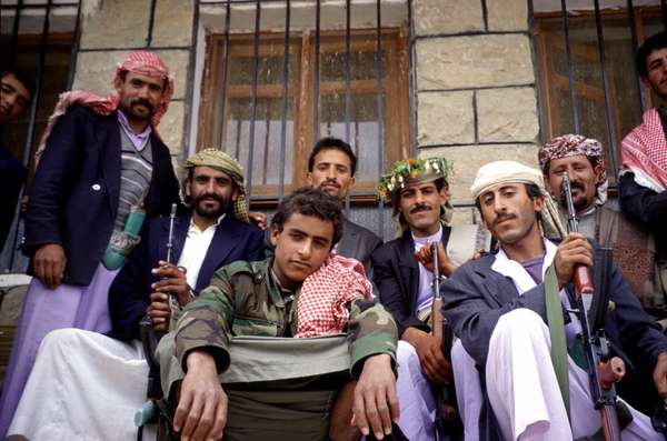 photo of Northern Yemen, tiny village in the Hajar mountains, this is not a guerilla group, but the friendly members of the family of te groom (in the back with the sweets in his hair) to whose wedding I was the honored guest