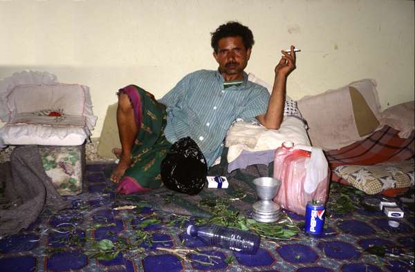 photo of Yemen, Yemeni man chewing qat with steel spitting bowl ready. Three quarters of Yemeni adults chew khat leaves each afternoon, for a period lasting at least five hours. People spend about one-quarter to one-third of their cash income on kat