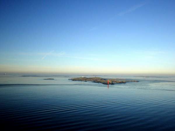 photo of Sweden, West Coast, tiny rock island in the beautiful Göteborg (Gothenburg) archipelago seen from the ferry between Göteborg and Denmark