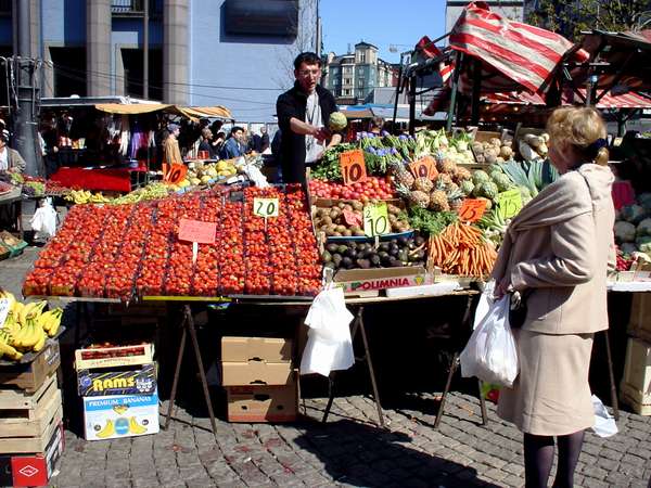 photo of Sweden, Stockholm, fruit seller on the Hötorget Market in central Stockholm. Most of the marketpeople are immigrants which will try to catch your attention with funny oneliners in a cosy kind of Swedish