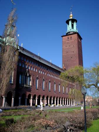 photo of Sweden, Stockholm, the Stadshuset (City Hall) seen from its garden. The building and tower are a landmark of Stockholm. In the Blue Hall, which is the building's largest hall, the Nobel Prize Banquet takes place on the 10th of December every year