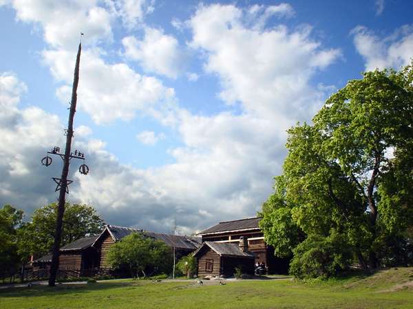 photo of Sweden, Stockholm, Skansen, old wooden houses and a Maypole around which midsummer festivities and dances are held the end of june