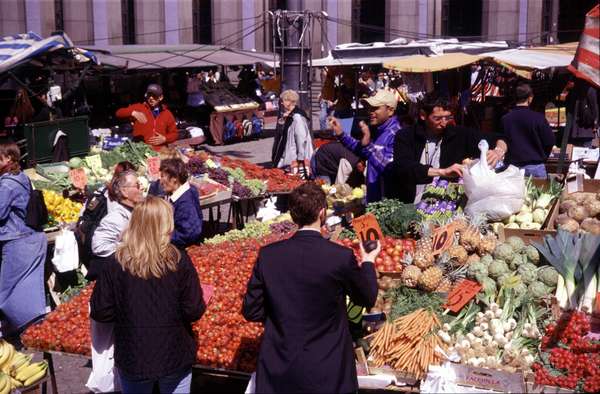 photo of Sweden, Stockholm, fruit seller on the Hötorget Market in central Stockholm. Most of the marketpeople are immigrants which will try to catch your attention with funny oneliners in a cosy kind of Swedish 