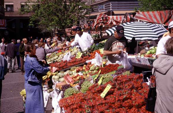 photo of Sweden, Stockholm, fruit seller on the Hötorget Market in central Stockholm. Most of the marketpeople are immigrants which will try to catch your attention with funny oneliners in a cosy kind of Swedish 