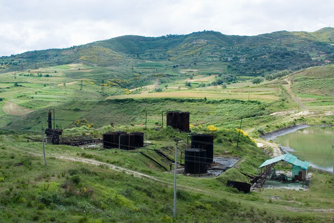 Albania photo around Fieri: Oil derrick, Petrol industry, Albanian Oil field. Albanian Ecology, environment, waste and pollution. 